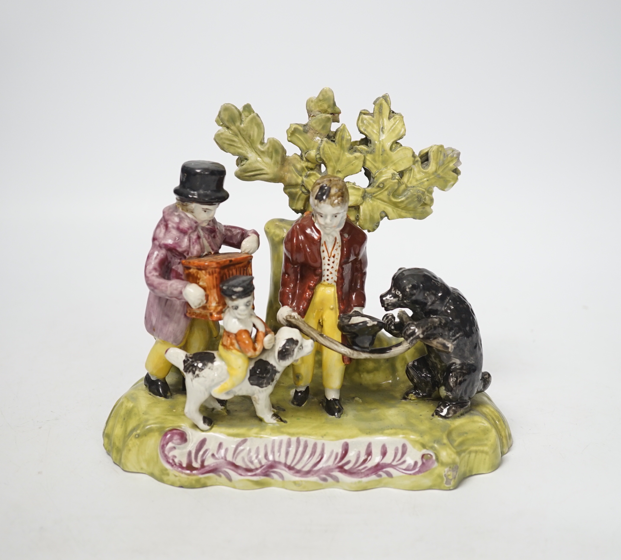 A Staffordshire pearlware group of a performing animal troupe with a dancing bear, c.1820-30, 15cm high